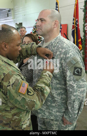 Sgt. Maj. Robert Goldsmith is awarded the Legion of Merit medal from Colonel Rodney Harris during Goldsmith's retirement ceremony. The Legion of Merit medal is awarded to servicemembers who show exceptional performance in a position of responsibility. (Mississippi National Guard photo by Spc. Justin Humphreys, 102d Public Affairs Detachment) Stock Photo