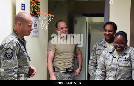 Master Sgt. Michael Bergquist, a chaplain assistant with the 379th Air Expeditionary Wing, engages with Airmen with the 379th Expeditionary Logistics Readiness Squadron during a “blitz,” at Al Udeid Air Base, Qatar, Nov. 30, 2016. The blitz is held at night so Airmen that work during those shifts can interact with 379 AEW Chaplain Corps and helping agency team members they don’t normally have face-to-face contact with. (U.S. Air Force photo by Senior Airman Cynthia A. Innocenti) Stock Photo