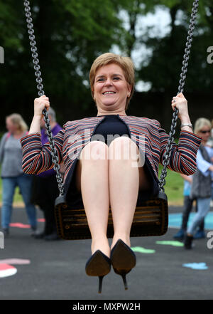 First Minister Nicola Sturgeon has a shot on a swing as she officially opened Play as One Scotland's fully inclusive play park at Pittencrieff Park in Dunfermline. Stock Photo