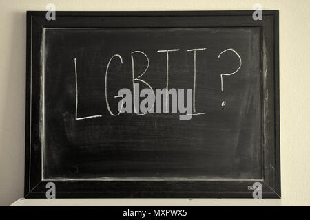 LGBTI written in white chalk on a blackboard. Stock Photo
