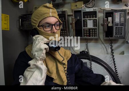 161205-N-AY934-021  SASEBO, Japan (Dec. 5, 2016) Petty Officer 3rd Class Rosemary Carter establishes communications from Repair Locker 7 to Damage Control Central during a general quarters drill aboard amphibious assault ship USS Bonhomme Richard (LHD 6). Bonhomme Richard, forward-deployed to Sasebo, Japan, is serving forward to provide a rapid-response capability in the event of a regional contingency or natural disaster. (U.S. Navy photo by Petty Officer 2nd Class Naomi VanDuser/Released) Stock Photo
