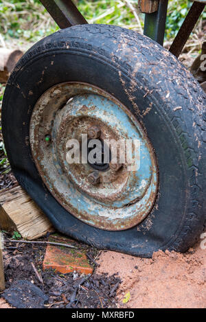 Old wheel of a car flat and rusty Stock Photo