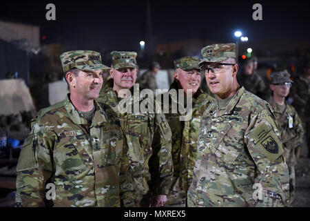 Air Force Gen. Joseph Lengyel, chief, National Guard Bureau; Army Lt. Gen. Timothy Kadavy, director, Army National Guard; Air Force Chief Master Sgt. Mitchell Brush, senior enlisted advisor to the chief of the National Guard Bureau; and Army Maj. Gen. John Thomson, commanding general, 1st Cavalry Division, watch toops play a flag footbal game during a Thanksgiving troop visit, Bagram Airfield, Bagram, Afghanistan, Nov. 23, 2016. (U.S. Army National Guard photo by Sgt. 1st Class Jim Greenhill) Stock Photo