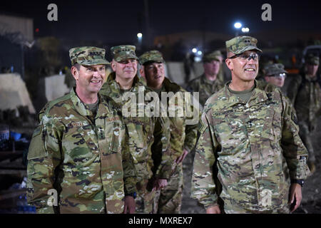 Air Force Gen. Joseph Lengyel, chief, National Guard Bureau; Army Lt. Gen. Timothy Kadavy, director, Army National Guard; Air Force Chief Master Sgt. Mitchell Brush, senior enlisted advisor to the chief of the National Guard Bureau; and Army Maj. Gen. John Thomson, commanding general, 1st Cavalry Division, watch toops play a flag footbal game during a Thanksgiving troop visit, Bagram Airfield, Bagram, Afghanistan, Nov. 23, 2016. (U.S. Army National Guard photo by Sgt. 1st Class Jim Greenhill) Stock Photo