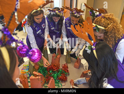 Spokane Lilac Festival Princesses put the finishing touches on bags full of cookies during the annual Operation Cookie Drop Dec. 6, 2016, at Fairchild Air Force Base. The Officer’s Spouses Club hosted the event and baked nearly 550 dozen cookies for Airmen living in the dormitories. (U.S. Air Force photo/Senior Airman Mackenzie Richardson) Stock Photo