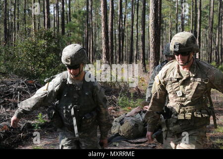 Soldiers assigned to the 5th Squadron, 7th Cavalry Regiment on Fort Stewart, transport a casualty during the Squadron's Spur Ride Dec. 6. Soldiers perform physical and mental tasks, such as disassembling and reassembling weapons, a ruck march, and land navigation, to earn their spurs.
