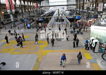 View of trains on track, platforms, armed soldiers and passengers walking at Gare du Nord train station in North Paris France Europe EU  KATHY DEWITT Stock Photo