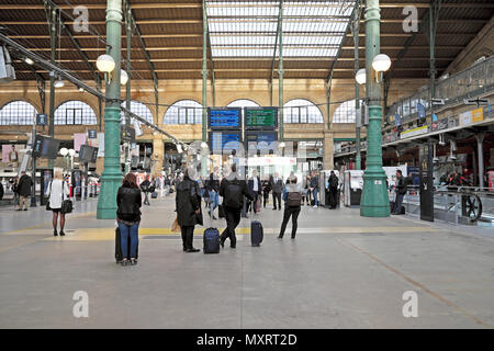 Interior view of passengers with luggage looking at arrival and departure screen Gare du Nord railway station in Paris France Europe EU KATHY DEWITT Stock Photo