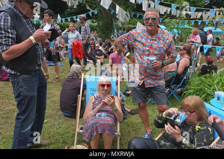 A group of older people on their phones at a festival Stock Photo