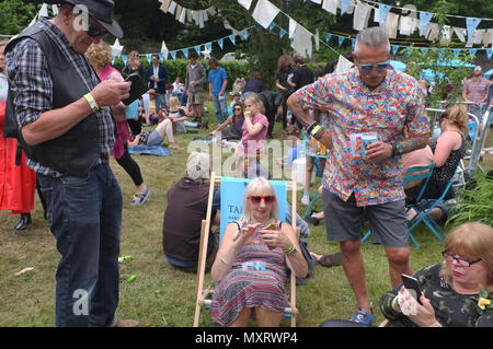 A group of older people on their phones at a festival Stock Photo