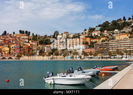 France, Cote d'Azur, Menton skyline and boats at bay waterfront, resort town on French Riviera at Mediterranean Sea Stock Photo
