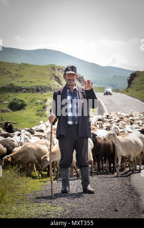 Areni, Armenia, 2nd June, 2018: armenian man herding his sheep in a countryside Stock Photo