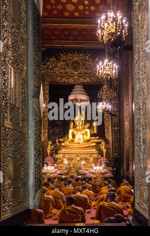 Wat Bowonniwet Vihara, monks at evening praying,Bangkok, Thailand, Stock Photo