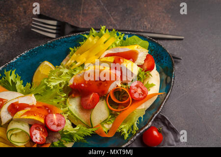 Pita bread with grilled chicken, hot sauce and vegetables, dark background. Turkish kebab, shawarma, greek gyros Stock Photo