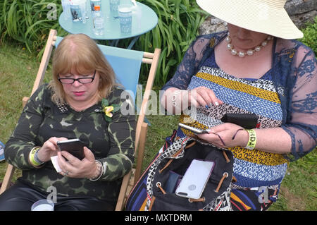 Two older women on their phones. Stock Photo