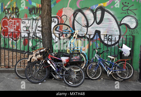 Bicycle parking in front of a wall filled with grffiti