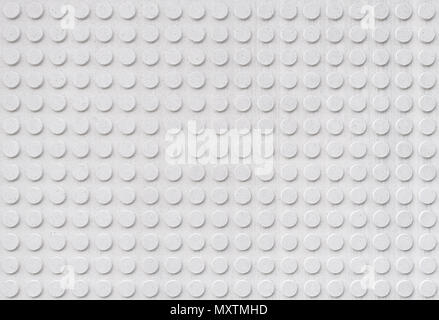Textured wall in symetrical circular embossed shapes repeating, light grey color. Stock Photo
