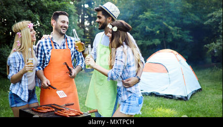 Happy friends enjoying barbecue party Stock Photo