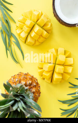 Tropical fruit pattern on yellow background. Fruits flat lay, healthy lifestyle and summer concept. Table top view Stock Photo
