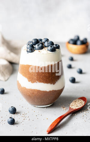 Chia pudding parfait with blueberries and yogurt. Healthy dessert or snack in a glass. Vegetarian, healthy lifestyle, healthy eating and dieting conce Stock Photo
