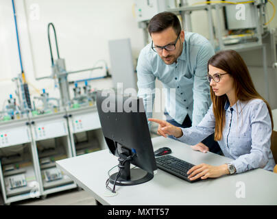 Young students presenting e-learning service in classroom Stock Photo