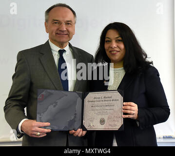 Dr. Andrew Michta, dean with the College of International Security Studies at the George C. Marshall European Center for Security Studies, presents Ulpia Botezatu, an analyst with the Space Critical Infrastructures Department of the Romanian Space Agency, with certificate for completing the Central and Southeast Europe Fellow Program Nov. 29. (Marshall Center photo by Christine June) Stock Photo