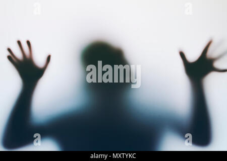 Man's silhouette in a foggy glass Stock Photo