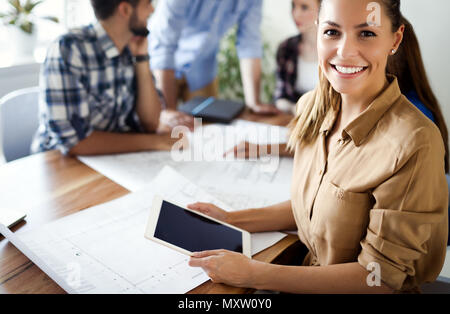 Business people and architects collaborating on project Stock Photo