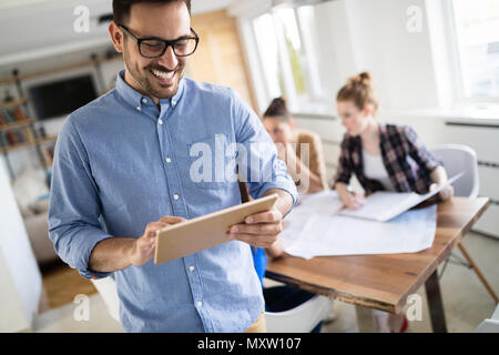 Business people and architects collaborating on project Stock Photo
