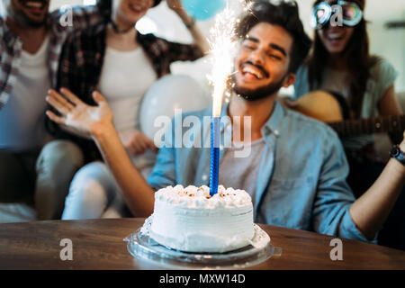Young group of happy friends celebrating birthday
