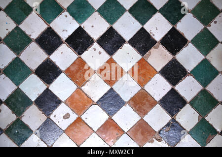floor in the medina of Fés with white, black, brown and green quadratic ceramic tiles Stock Photo