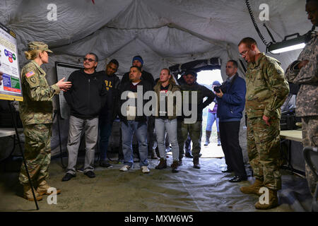 UFC fighters Ben Rothwell, Valentina Shevchenko, and Lorenz Larkin meet with U.S. Army Soldiers from the 690th Rapid Port Opening Element at Joint Base Langley-Eustis, Va., Dec. 8, 2016. During the visit, the Soldiers demonstrated their rapid deployment capabilities and took the fighters on a convoy. (U.S. Air Force photo by Tech. Sgt. Katie Gar Ward) Stock Photo