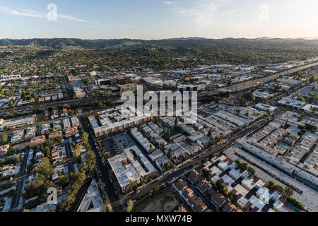 Aerial view of Ventura 101 Freeway, apartment rooftops and the Santa Monica Mountains in the San Fernando Valley area of Los Angeles, California. Stock Photo