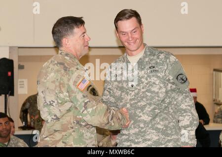 Spc. Matthew Kreps, 1st-18th Military Police (Airborne), receives recognition from Maj. Gen. Daniel Ammerman, commanding general, USACAPOC, for being the first Soldier in line during the Operation Toy Drive XIX lottery day on December 9 at Fort Bragg, N.C. Kreps, Rancho Cucamonga, Calif,. said he was excited to be able to attend the lottery day jump and believes the training is an invaluable experience. (US Army Reserve photo by Sgt. Darryl L. Montgomery, 319th Mobile Public Affairs Detachment) Stock Photo