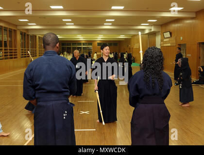 CAMP KENGUN, Kumamoto City, Kumamoto Prefecture, Japan – Kodai Atobe, a Kumamoto city police officer, gives Kendo instructions to U.S. soldiers Dec 9. The soldiers attended Kendo training at the police station to foster good relations between the U.S. military and the Japanese people during Yama Sakura 71. Exercise Yama Sakura 71 is an annual command post exercise co-sponsored by U.S. Army Pacific and the JGSDF at Camp Kengun from Dec. 1-13. The purpose of the exercise is to enhance U.S. and Japan’s combat readiness and interoperability while strengthening bilateral relationships and demonstra Stock Photo