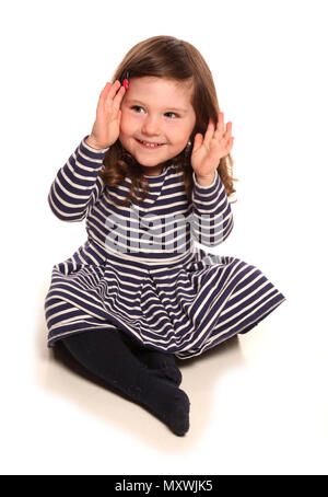 toddler girl playing peek a boo in a studio Stock Photo