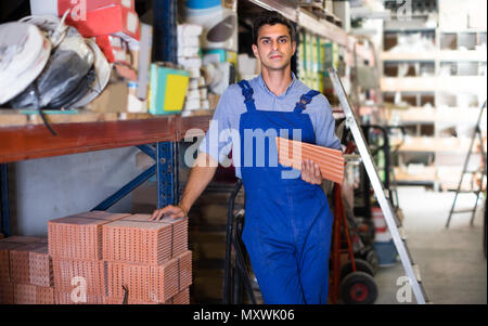 Foreman is choosing tiles in the building store. Stock Photo