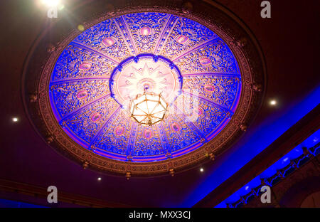 This is an ornate, vintage and very detailed ceiling light in an interior. Stock Photo