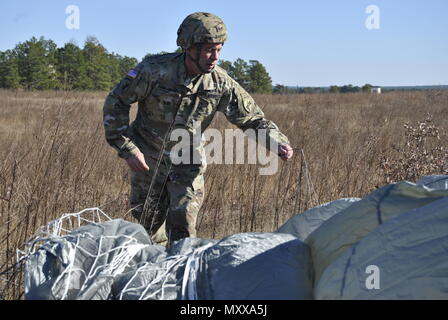 Maj. Gen. Daniel Ammerman, Commanding General of US Army Civil Affairs and Psychological Operations Command (Airborne), retrieves his parachute during an airborne operation for the XIX Annual Randy Oler Memorial Operation Toy Drop, hosted by U.S. Army Civil Affairs & Psychological Operations Command (Airborne), at Luzon Drop Zone, N.C., Dec. 10, 2016. Operation Toy Drop is the world’s largest annual joint combined airborne operation and collective training exercise with paratroopers from eight partner-nations participating. (U.S. Army Photo by Spc. Jesse L. Artis Jr./Released) Stock Photo