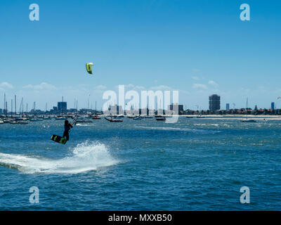 Kite surfer taking off from waters of Port Phillip Bay by St Kilda marina and pier, Melbourne, Victoria, Australia Stock Photo