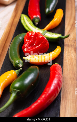 Colorful fresh hot Mexican chili peppers in assortment Stock Photo