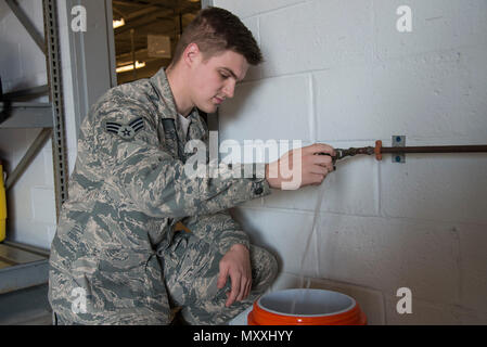 Senior Airman Alexander Delfs, 436th Aerospace Medicine Squadron bioenvironmental engineering journeyman, adjusts water flow for a water test Nov. 16, 2016, at an aircraft watering point on Dover Air Force Base, Del. In addition to conducting water tests at aircraft watering points, members of this unit also test the water at the installation’s youth-age programs facilities. (U.S. Air Force photo by Senior Airman Aaron J. Jenne) Stock Photo