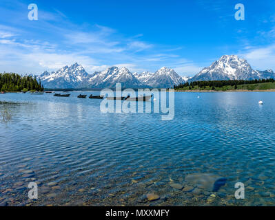 Blue Mountain Lake - A spring view of crystal clear Jackson Lake, with Teton Range towering in the background, in Grand Teton National Park, USA. Stock Photo
