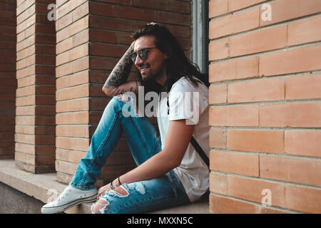 Attractive young man wearing sunglasses Stock Photo