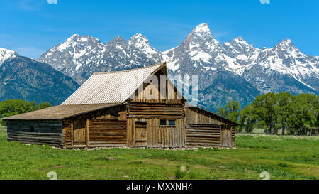 Moulton Barn - A spring morning view of Moulton Barn and Teton Range in Mormon Row historic district of Grand Teton National Park, Wyoming, USA. Stock Photo