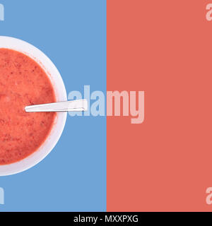 Fresh homemade yogurt, strawberries and sour cream mixed by using blender, top view, mixed colored background with copy space for text Stock Photo
