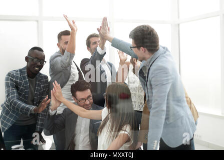 members of the business team giving each other a high five Stock Photo ...