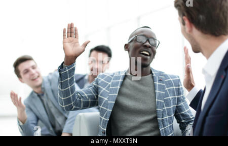 employees giving each other high five Stock Photo - Alamy