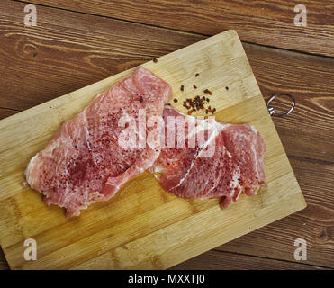 Raw cut meat on a wooden board. Pork chunks for chops , cooking pork chop, Stock Photo