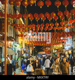 London, UK - October 2017. Tourists at night in Gerrard Street, in the heart Chinatown in Soho. Square format. Stock Photo